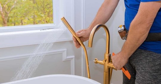 plumber installing bathroom hardware